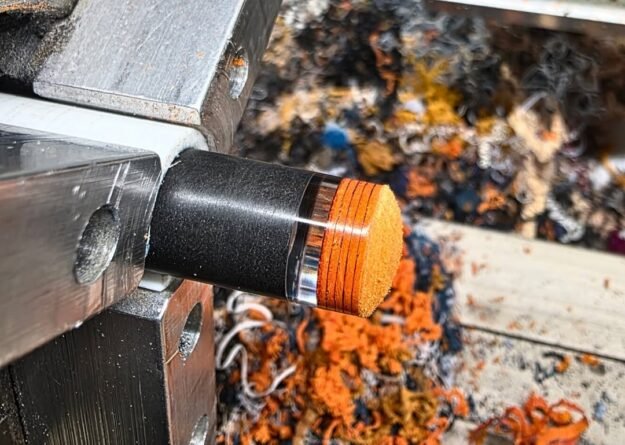 Pool cue tip and ferrule being shaped on a lathe